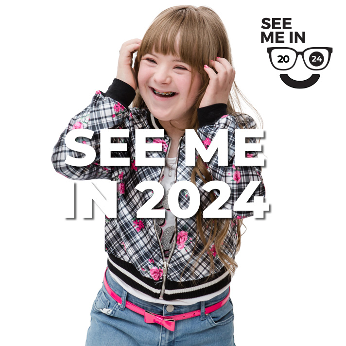 See Me in 2024 Button Model Posing putting hair behind her ears.